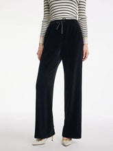 a woman in black culottes pants